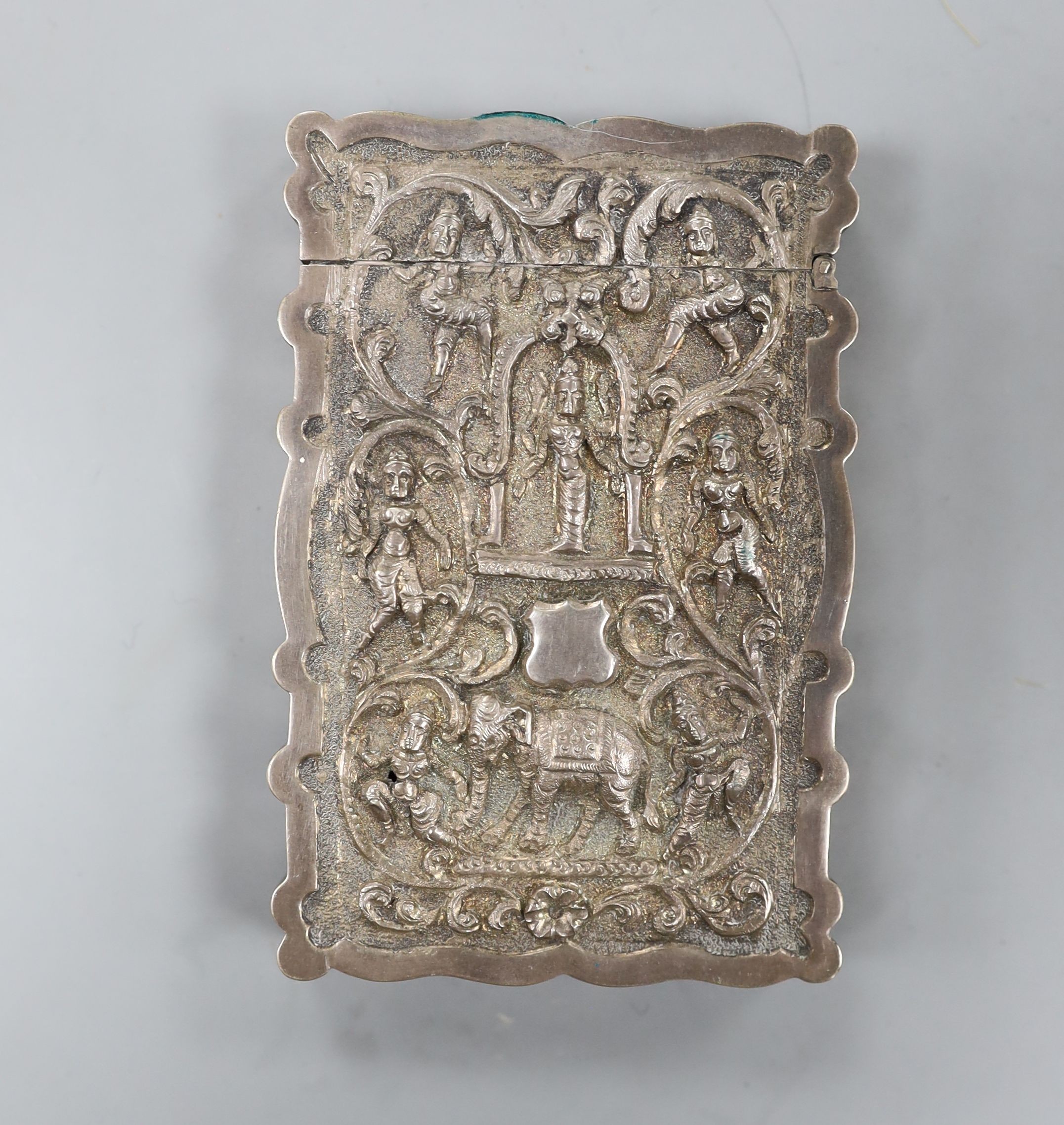 An Indian embossed white metal card case, decorated with figures and elephants, 97mm